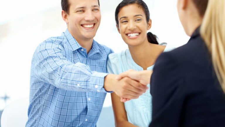 Couple Shaking Hands With Agent (1600 × 900 px)